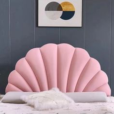 a pink shell shaped bed in a bedroom