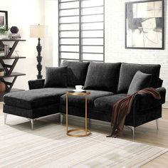 a living room with a sectional couch and coffee table on the floor in front of it