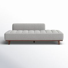 a gray couch sitting on top of a white floor