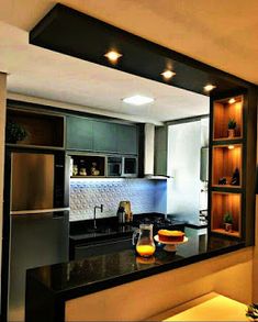 a modern kitchen with stainless steel appliances and black counter tops