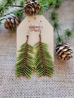 the earrings are made out of beads and pine cones