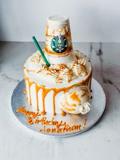 there is a cake that has been decorated with the starbucks logo on it and icing