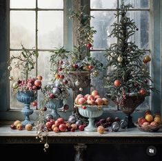 a table topped with vases filled with fruit next to an open window sill