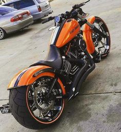 an orange and black motorcycle parked on the street