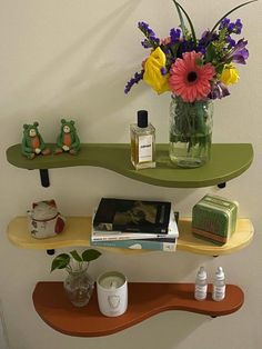 two shelves with flowers and books on them