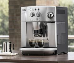 an espresso machine sitting on top of a wooden table