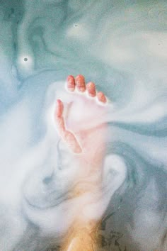 a person's feet in the water with their toes up