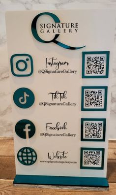 Q Signature Gallery social media sign with teal mirror icons and QR codes Business Qr Code Signs, Qr Codes Business Card, Vendor Social Media Sign, Creative Qr Code Display, Social Media Signage, Social Media Office Design, Diy Social Media Sign, Qr Code Social Media Design, Qr Code Plaque