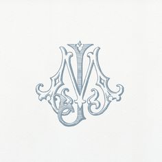 the letter m is made up of ornate scrolls and swirls in blue on white paper