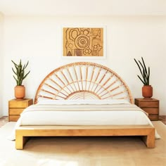 a bamboo bed frame with white sheets and pillows in a modern style bedroom, with potted plants on either side