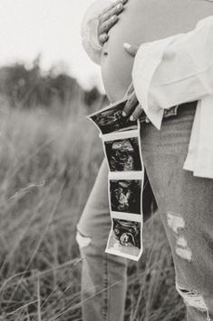 a pregnant woman is holding her belly with pictures on it's side in the grass