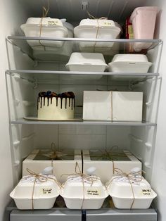 the shelves are filled with cakes and containers