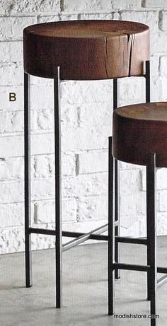 two stools sitting next to each other in front of a white brick wall and floor