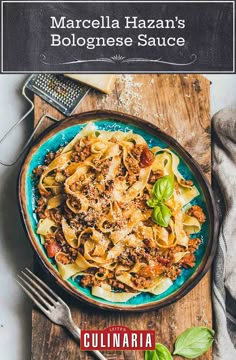 a plate of pasta with meat, cheese and basil on a wooden cutting board next to a grater