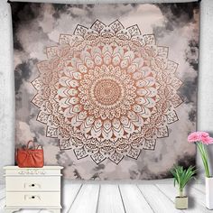 a wall hanging tapestry with an orange and white flower on it