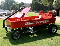 a radio flyer car is parked in the grass