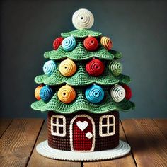 a small crocheted christmas tree on top of a wooden table