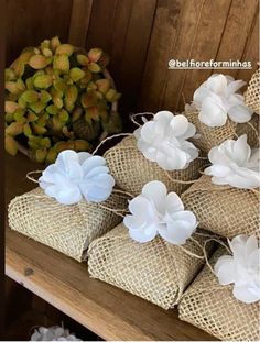 several bags filled with white flowers on top of a wooden table