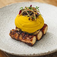 a white plate topped with food on top of a wooden table