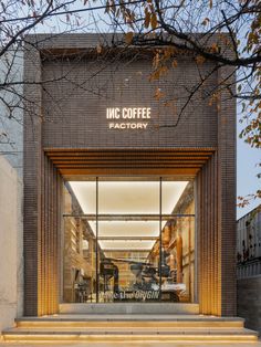 the entrance to an inc coffee factory with stairs leading up to it's doors