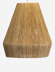 a lamp that is made out of straw and has a white cord hanging from it