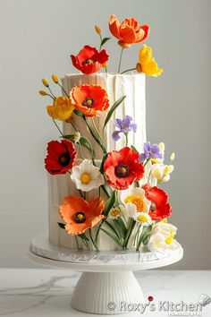 a white cake with colorful flowers on top