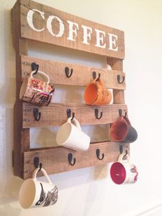 a coffee cup rack with cups hanging on it