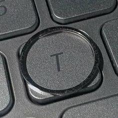 a close up of a computer keyboard with the t on it