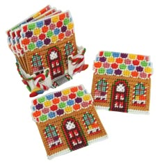 four small coasters made out of crochet and bead, each with a gingerbread house on the front