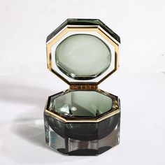 This beautifully colored and elegant Modernist Hand-Blown Murano Octagonal Glass Box in Emerald W/Brass Fittings originates from Italy during the 21st Century. Features an octagonal profile rendered in hand-blown murano glass, transparent along the outside edges with an emerald green hue surrounding the interior space of the box. Lined and hinged with elements in polished brass, the materials balance beautifully in this well weighted and formed piece, styling beautifully in a wide array of setti Unique Mens Gifts, Drake Design, Dream Accessories, Minimal Interiors, Jewelry Box Design, Design Showroom, Glass Transparent, Glass Jewelry Box, Transparent Box