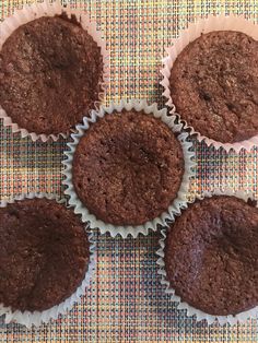 six chocolate muffins sitting on top of a table