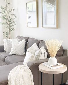 Celebrate boho elegance with this gray chaise lounge sofa positioned under wood frame artwork. The sofa is accompanied by an indoor tree and a round light wood and black metal side table. Use beige pampas grass decor in a white vase as a finishing touch on the table...   Image: nita_home