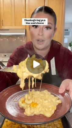 a woman is eating macaroni and cheese from a plate