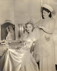 an old black and white photo of two women getting ready for their wedding day at the same time