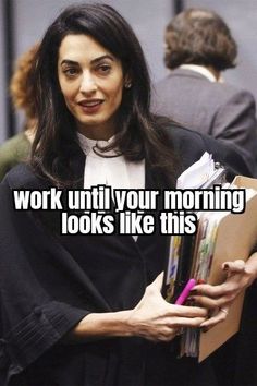 a woman in a court gown holding a folder and smiling at the camera with words on it