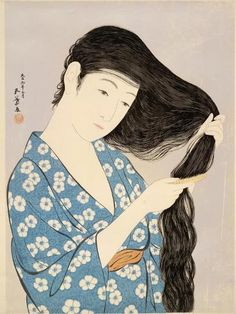 a woman with long black hair is holding her head in one hand and wearing a blue kimono on the other