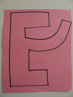 a pink piece of paper with the letter f drawn in black on top of it