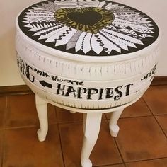 a white and black painted stool with the words happpiest on it