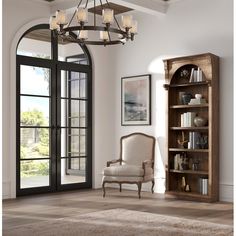 a living room filled with furniture and a book case in front of a large window