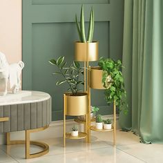 three plant stands with plants in them on the floor next to a chair and table