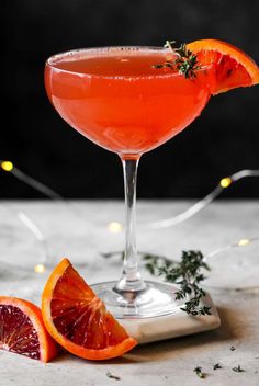 a blood orange cocktail garnished with rosemary