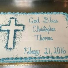 a cake decorated with blue frosting and a white cross on the side that says, god bless christop thomas february 4, 2016