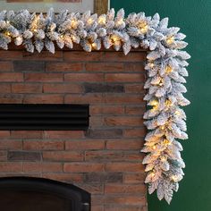 a fireplace decorated with christmas lights and garland