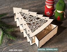 wooden cutout christmas trees with snowflakes and mittens on the table next to them