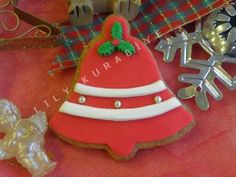 decorated cookies are sitting on a table next to other christmas decorations and cookie cutters