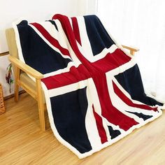 a blanket that is sitting on top of a wooden chair in front of a window