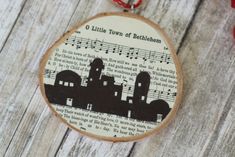 a wooden ornament with an image of a building and music notes on it