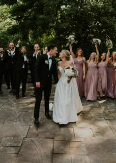 the bride and groom are surrounded by their wedding party