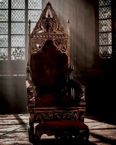 an old chair sitting in the middle of a room