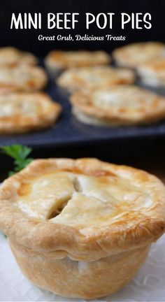 A mini pot pie on a plate with a muffin tin full of pot pies in the background.